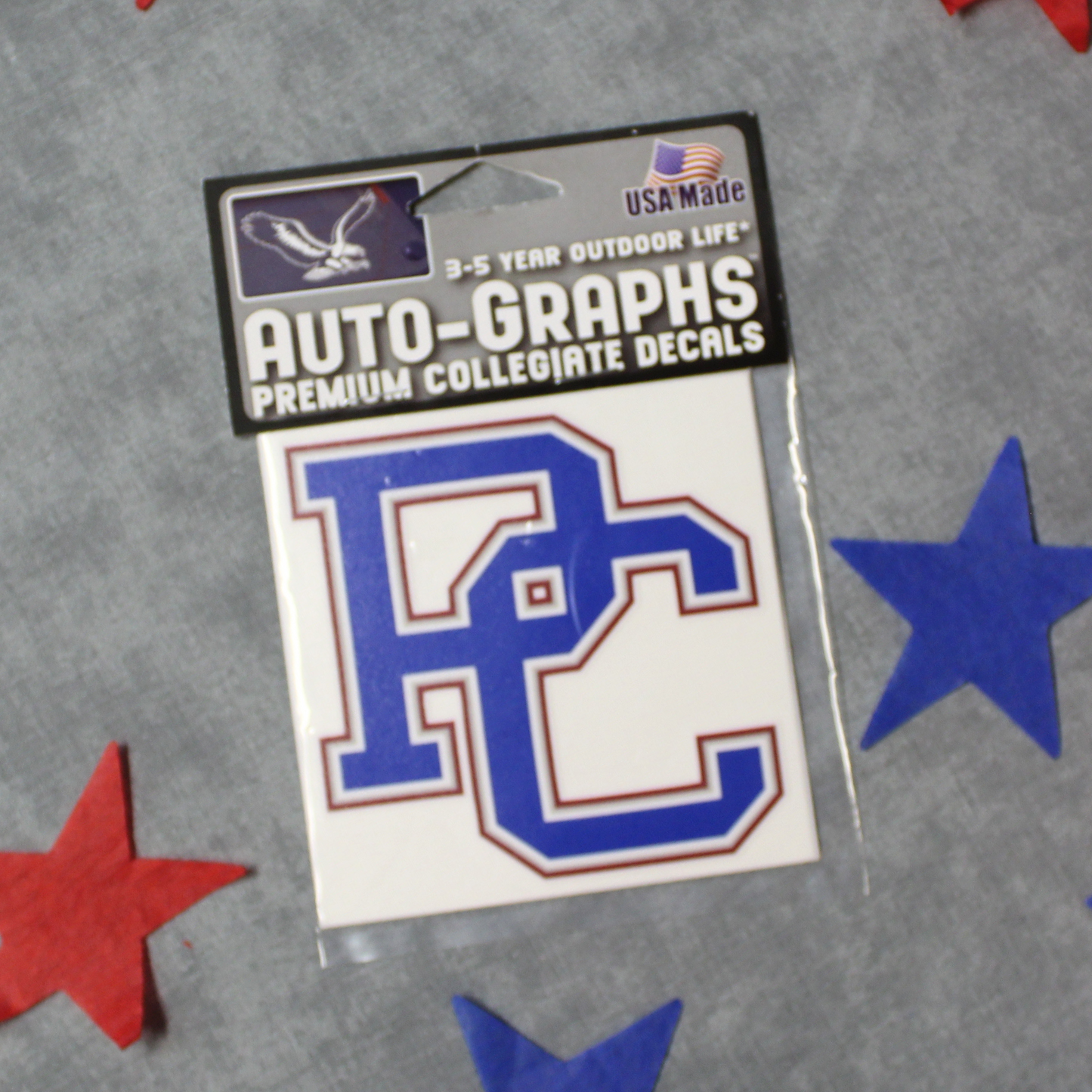 A decal with a blue, red, and white color scheme featuring the block PC logo. the background of this product photo has red and blue stars on it.
