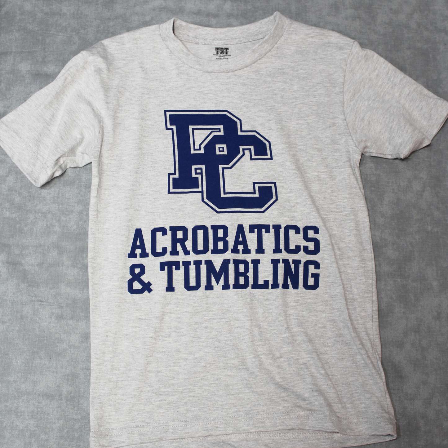 light grey heather t-shirt white royal blue graphic of the PC logo and Acrobatics and Tumbling.