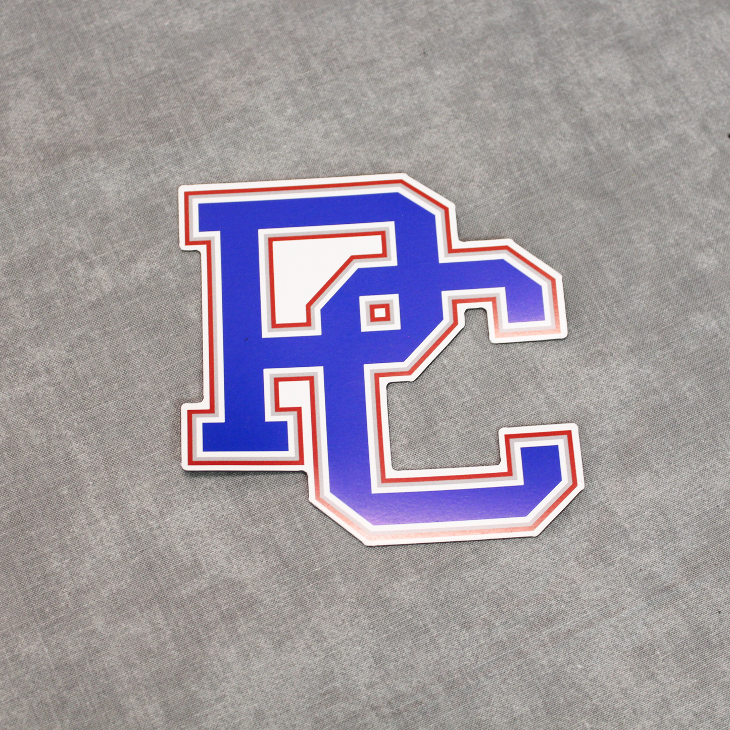 A picture of the Presbyterian College block 4 color PC logo magnet in blue, red, grey and white.
