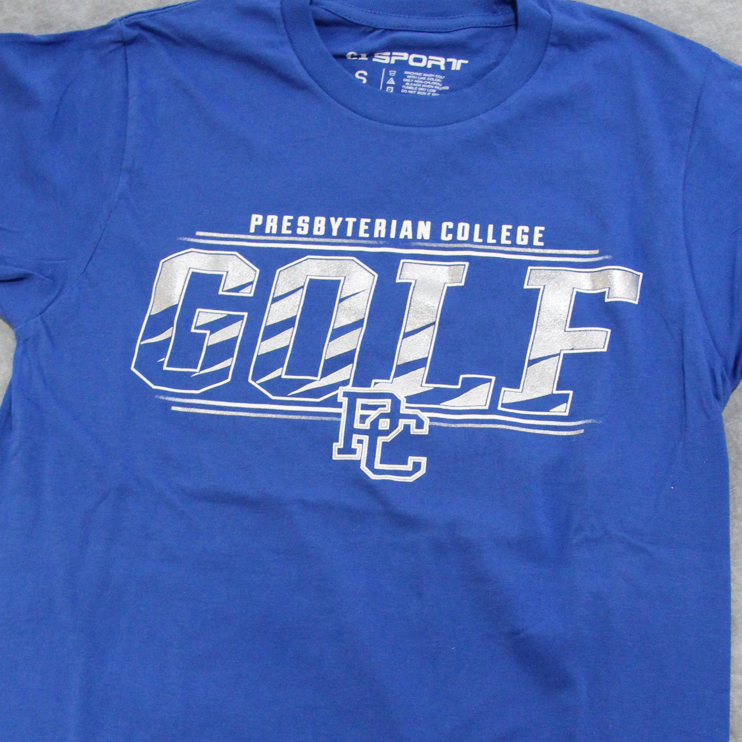 Product photo of a royal blue t-shirt with a silver ink screen print graphic "Presbyterian College Golf".