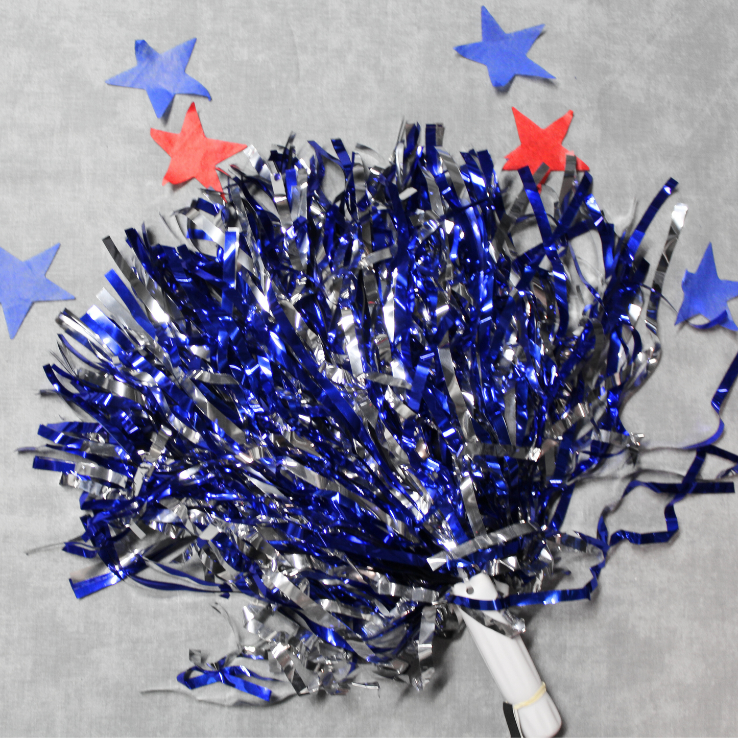 Royal Blue and silver metallic pom pom. The background of this image features red and blue stars.