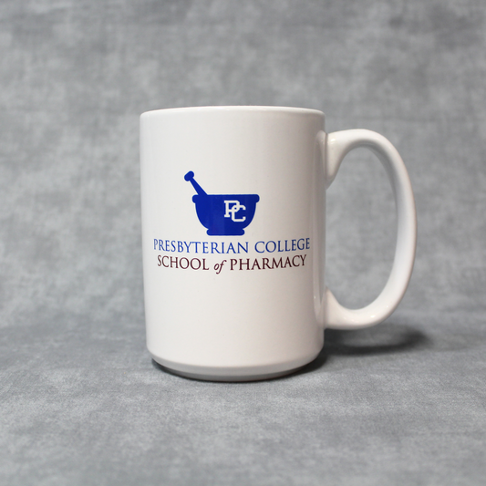 Product photo of a white mug with the Presbyterian College School of Pharmacy logo across the middle of the mug in blue and red ink.