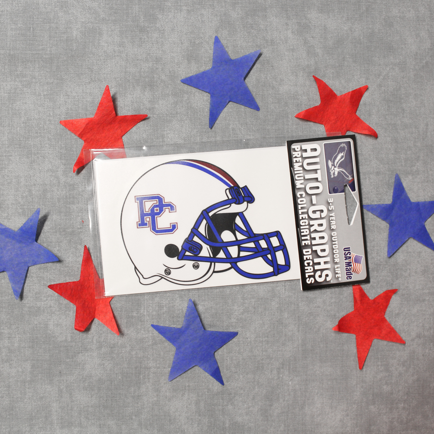 Decal of a white football helmet with a blue and red block PC logo on it. The background of this product photo has red and blue stars on it.