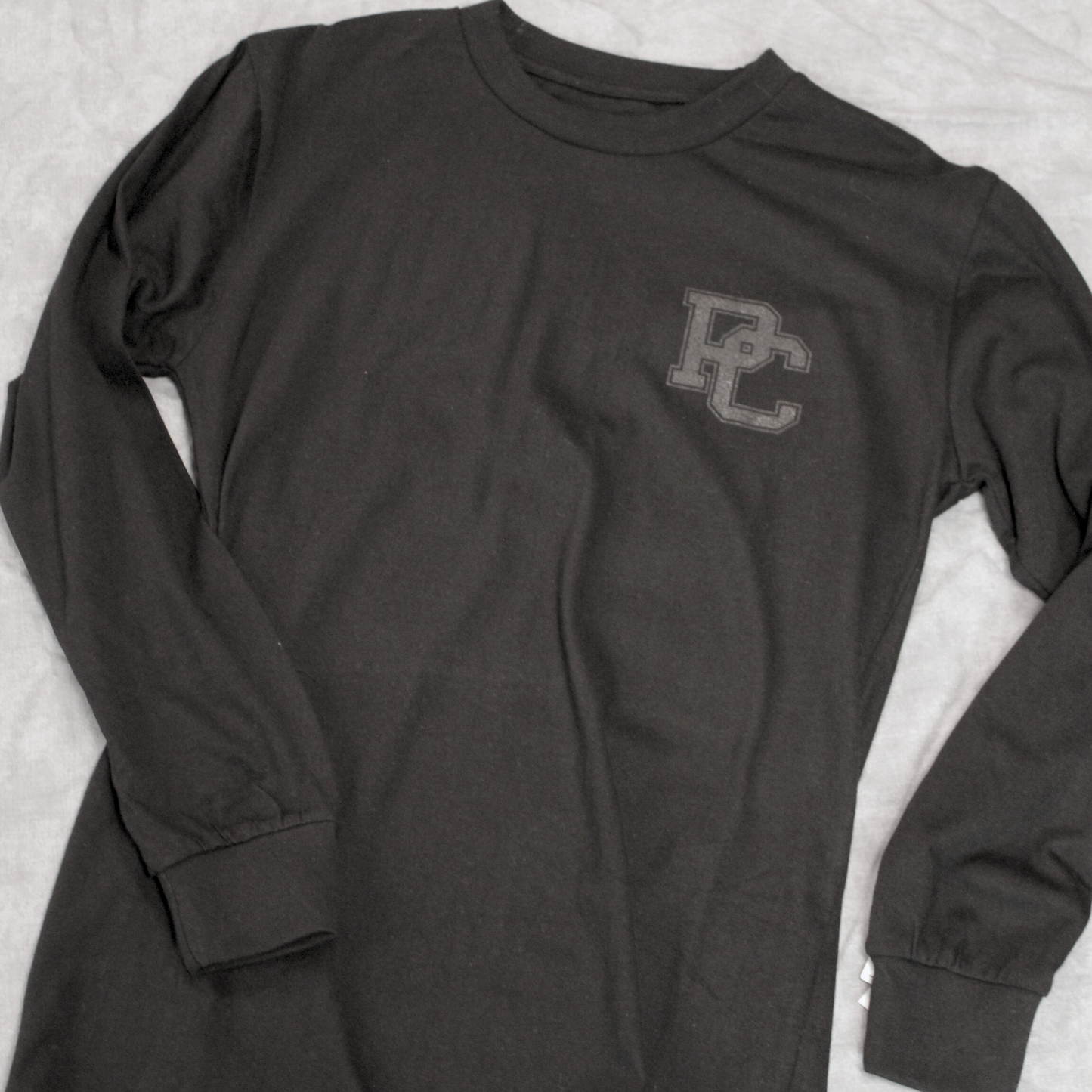 Another view of the black ink PC on a black long sleeve shirt.