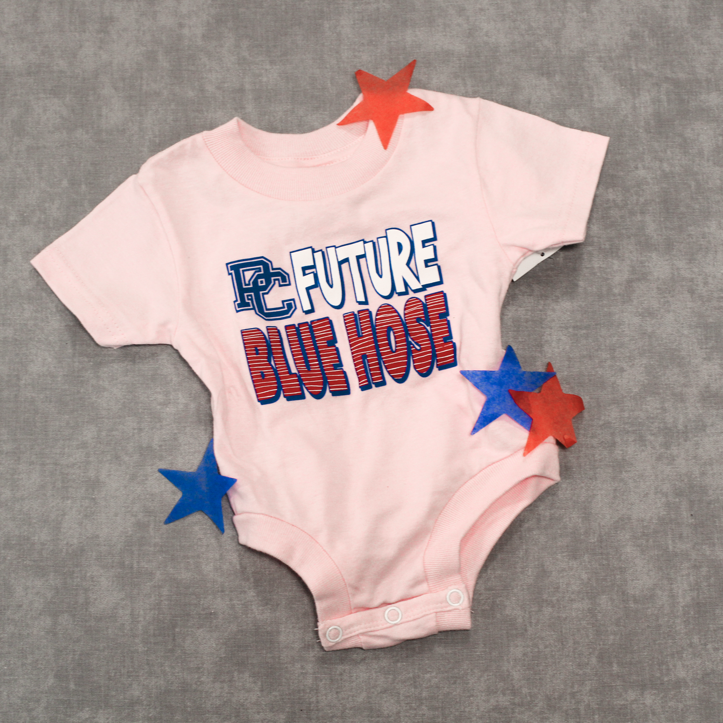 Light pink infant onesie with PC Future Blue Hose screen printed on the front in navy, white, and red ink.