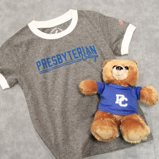 Product photo of a light grey youth ringer style t-shirt with white piping around the collar and sleeves. The shirt has "Presbyterian College" printed on the front of the shirt in royal blue. The product photo also includes a brown teddy bear in it.