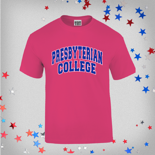 Product photo of a hot pink youth t-shirt that features an arched Presbyterian College graphic in blue and white ink across the front of the shirt. The background of the product photo has red, white, and blue stars.