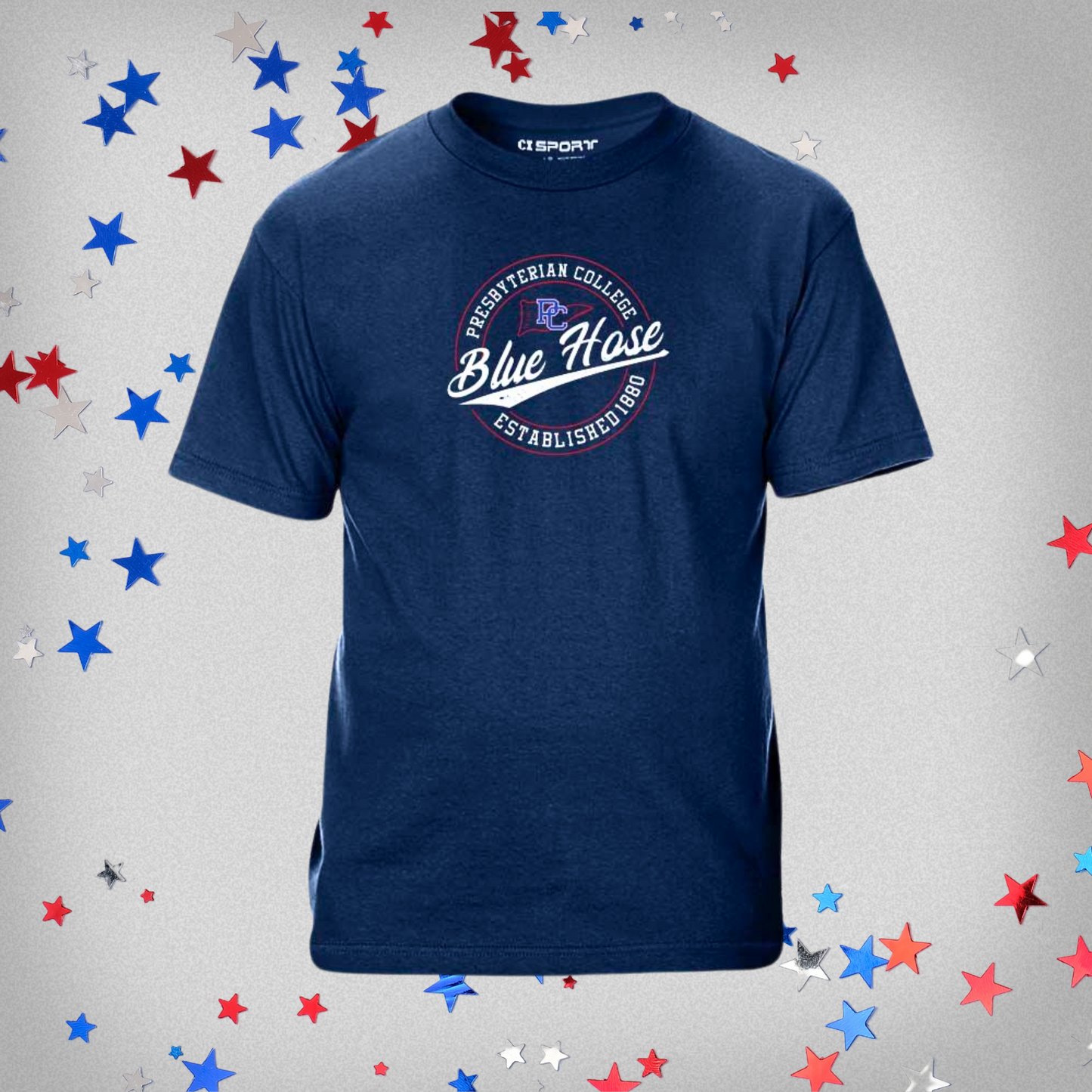 Navy Blue T-shirt with a circular design that has Presbyterian College Blue Hose Established 1880 along with a little flag outline with the block PC logo on it. The screen print design is mostly white, with some red and royal blue ink details. The background of this product photo contains blue, red, and white stars.