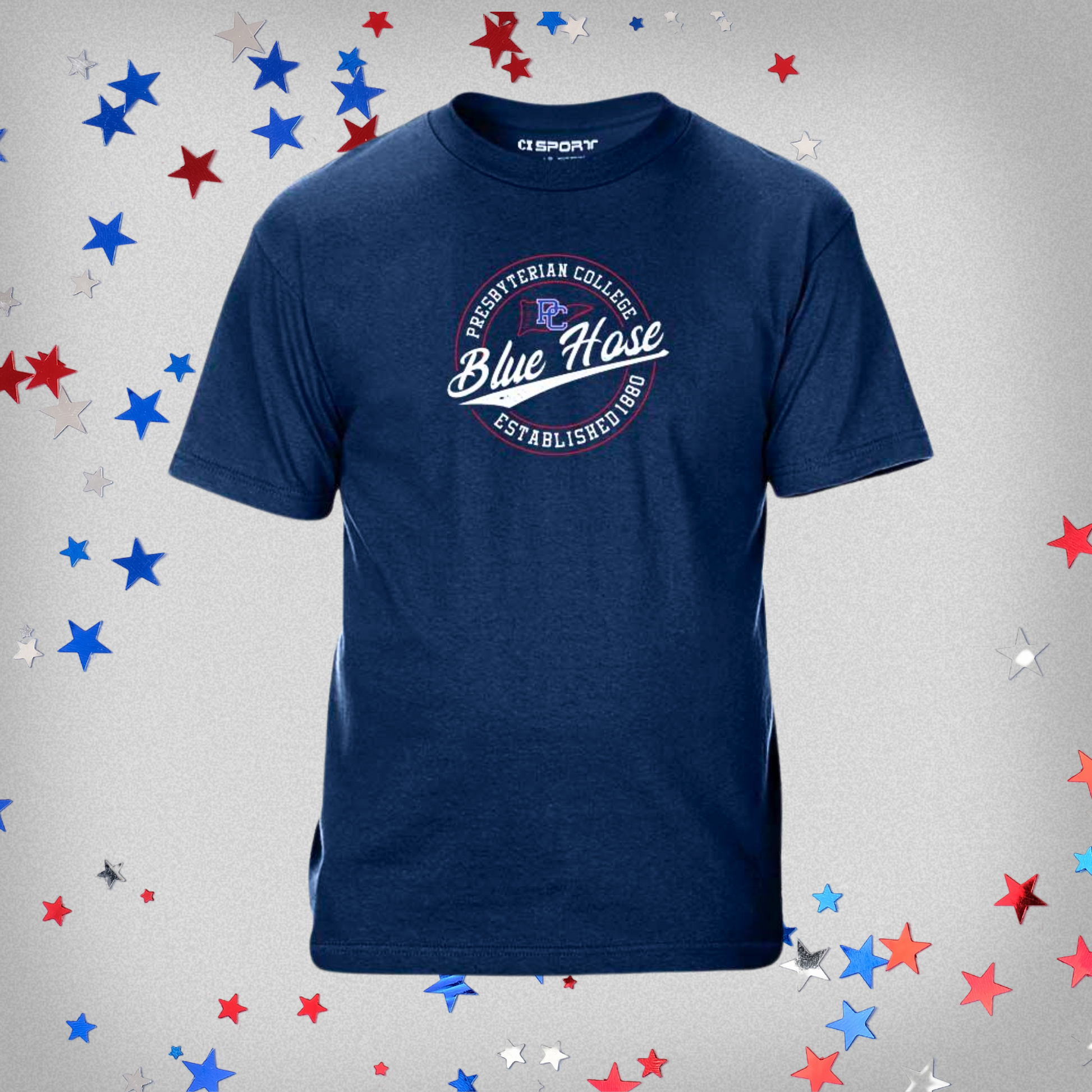 Navy Blue T-shirt with a circular design that has Presbyterian College Blue Hose Established 1880 along with a little flag outline with the block PC logo on it. The screen print design is mostly white, with some red and royal blue ink details. The background of this product photo contains blue, red, and white stars.