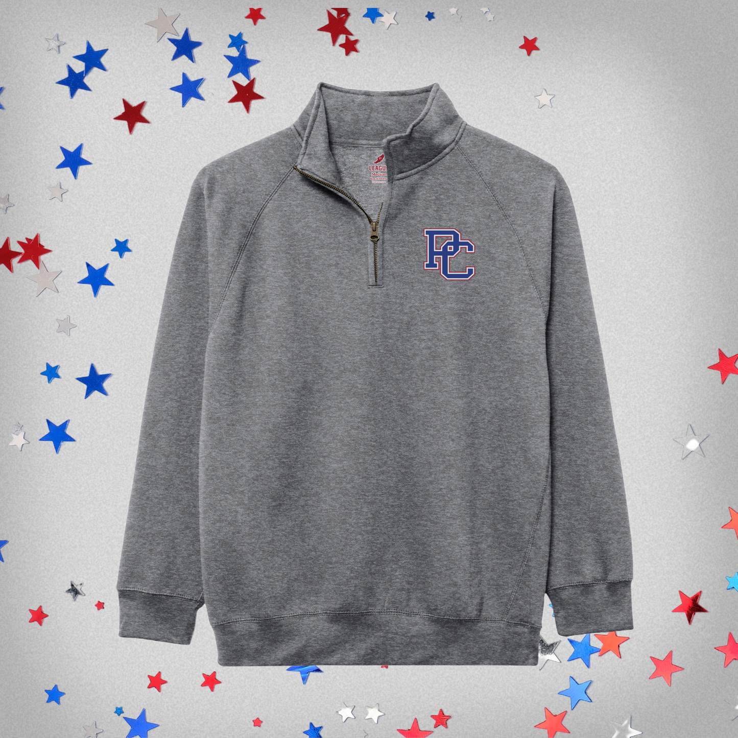 Product photo featuring a heather grey quarter zip with a 4 color block PC logo embroidered on the top left chest. Background of product photo has blue, red, and white stars.