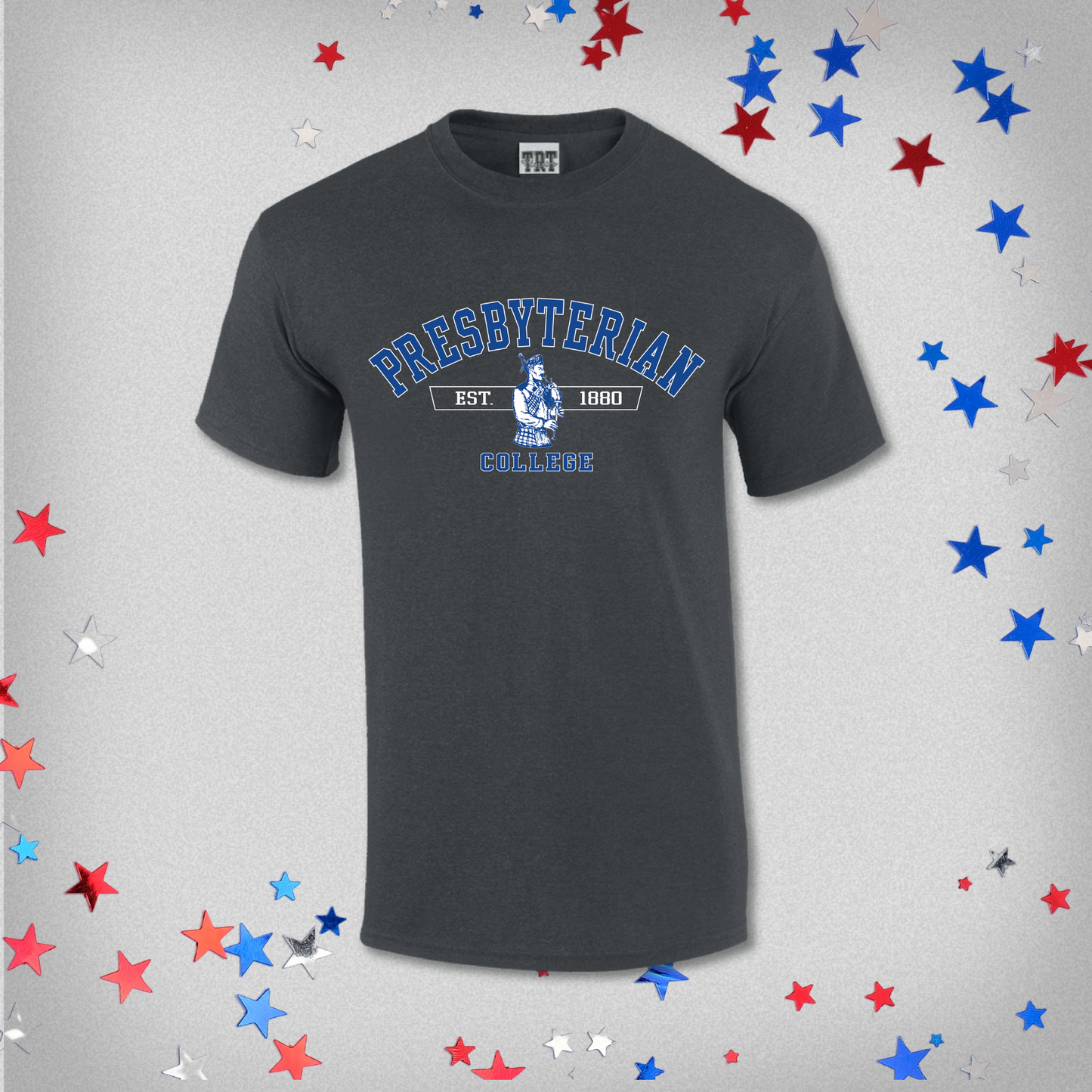 Presbyterian College dark grey t-shirt with a royal and white screen print graphic of a scotsman playing bagpipes, and Presbyterian College est 1880 on it. The background of this product photo has red, white, and blue stars on it.
