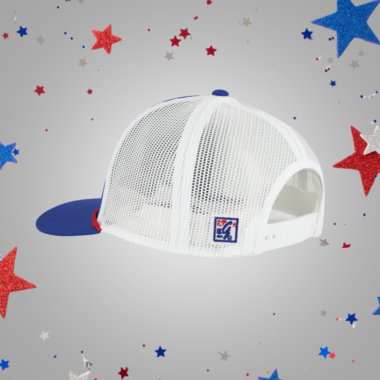 A white mesh trucker-style cap, shown on a light gray background with scattered red, white, and blue glitter stars.