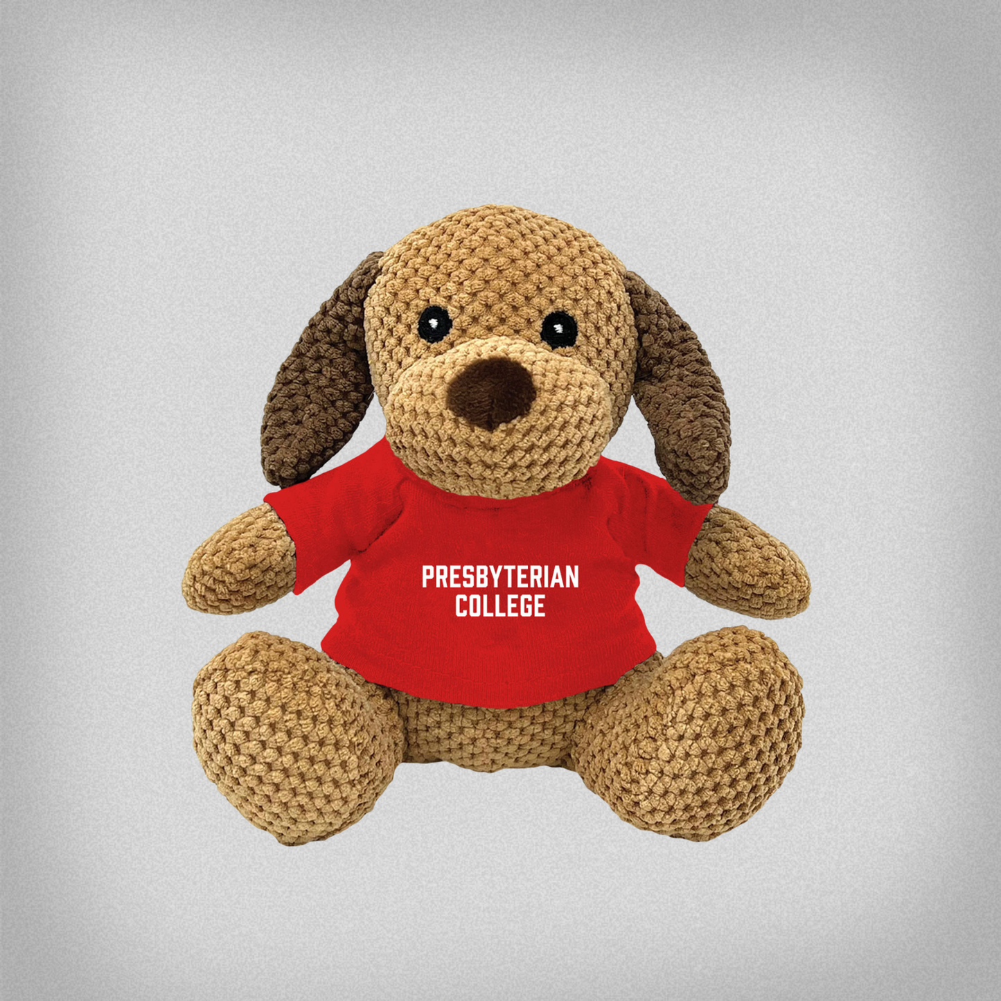 Stuffed dog plush animal wearing a red shirt with 'Presbyterian College' on it