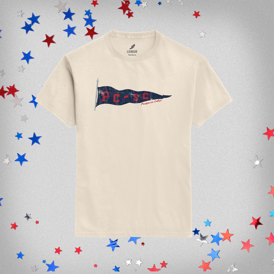 Beige t-shirt with a navy PC-SC flag design on a gray background with star confetti.