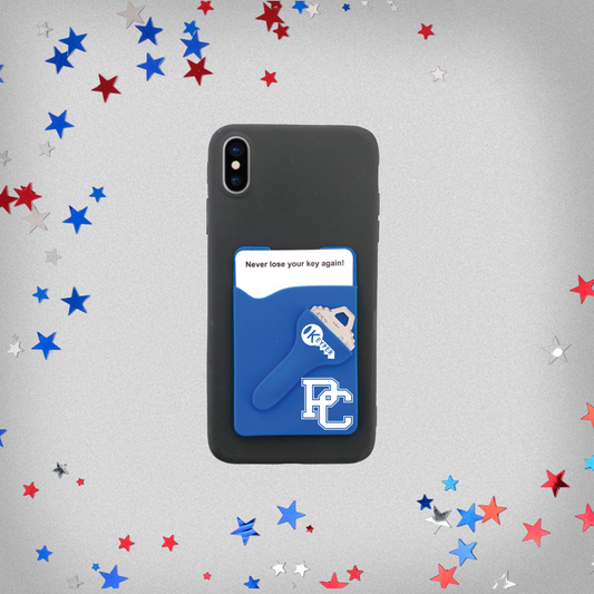 product image of a royal blue silicone phone wallet with a slot for a card and a key. The background of this product photo has red, white, and blue stars on it.