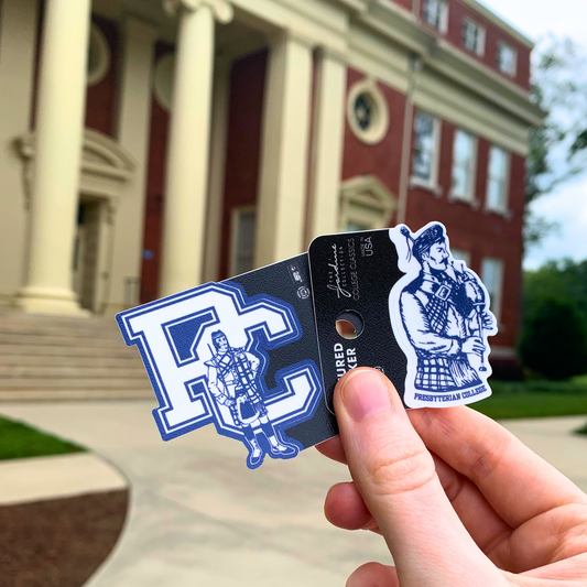Photo of the bagpipe scotsman sticker and the vintage 80s scotsman sticker in front of Neville Hall at presbyterian College.