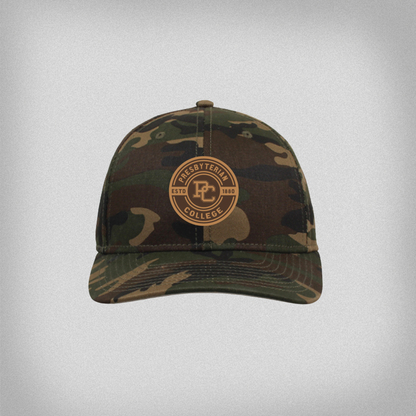 Camouflage baseball cap with 'Presbyterian College Estd 1880' and the block PC logo on a circular lego patch on the front.