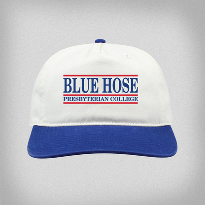 White cap with blue brim and red and blue embroidered design.