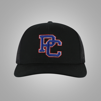 A black trucker-style baseball cap with a curved brim and a large embroidered 'PC' logo on the front panel, outlined in red and filled with blue, set against a neutral gray background.