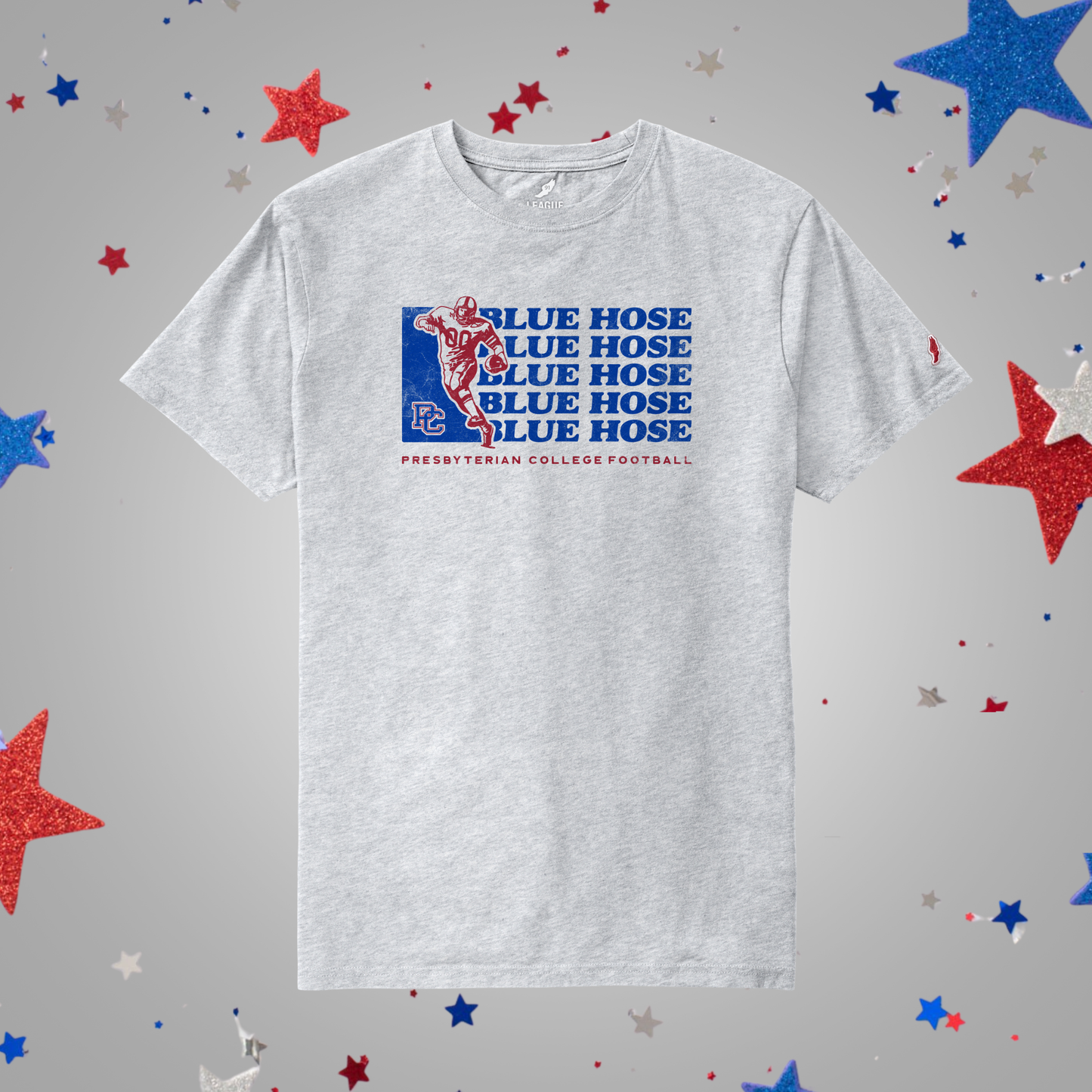 An ash gray t-shirt featuring a blue and red 'Blue Hose' Presbyterian College Football graphic on the chest, displayed against a gray background decorated with red, white, and blue glittery stars.