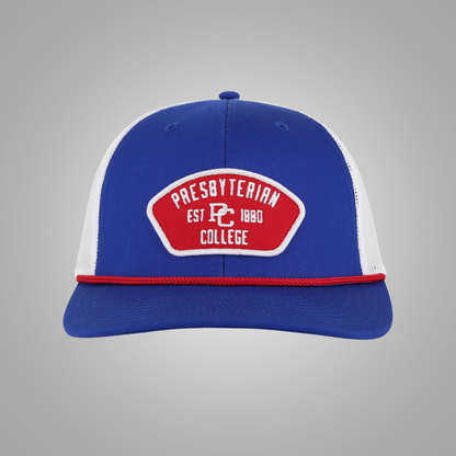 A royal blue and white trucker-style baseball cap with a red and white embroidered patch on the front reading 'Presbyterian Est PC 1880 College'.