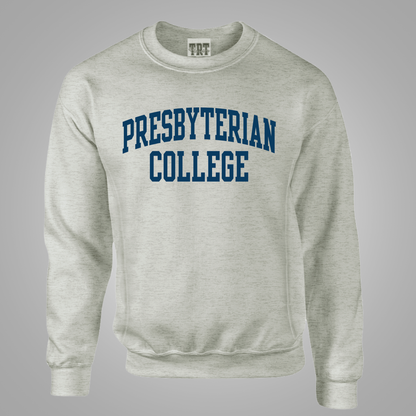 An oatmeal crewneck sweatshirt featuring the words 'PRESBYTERIAN COLLEGE' printed in navy blue varsity-style block letters across the chest, displayed on a neutral gray background.
