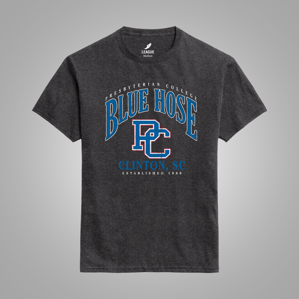 A dark heather black t-shirt with a blue and white graphic print on the front reading 'Presbyterian College Blue Hose Clinton, SC'. The shirt is displayed against a neutral gray background.