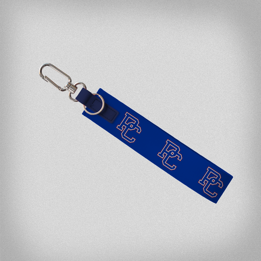 Royal blue oversize strap keychain with block PC repeated across the strap 