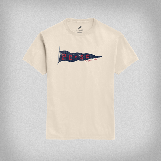 Beige t-shirt with a vintage navy PC-SC flag graphic design on a gray background